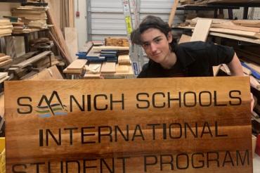 International student showing new sign created for SISP
